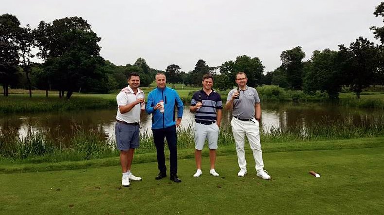 Golfer Simon Prestcote and friends celebrate after their 100 in 1 day challenge
